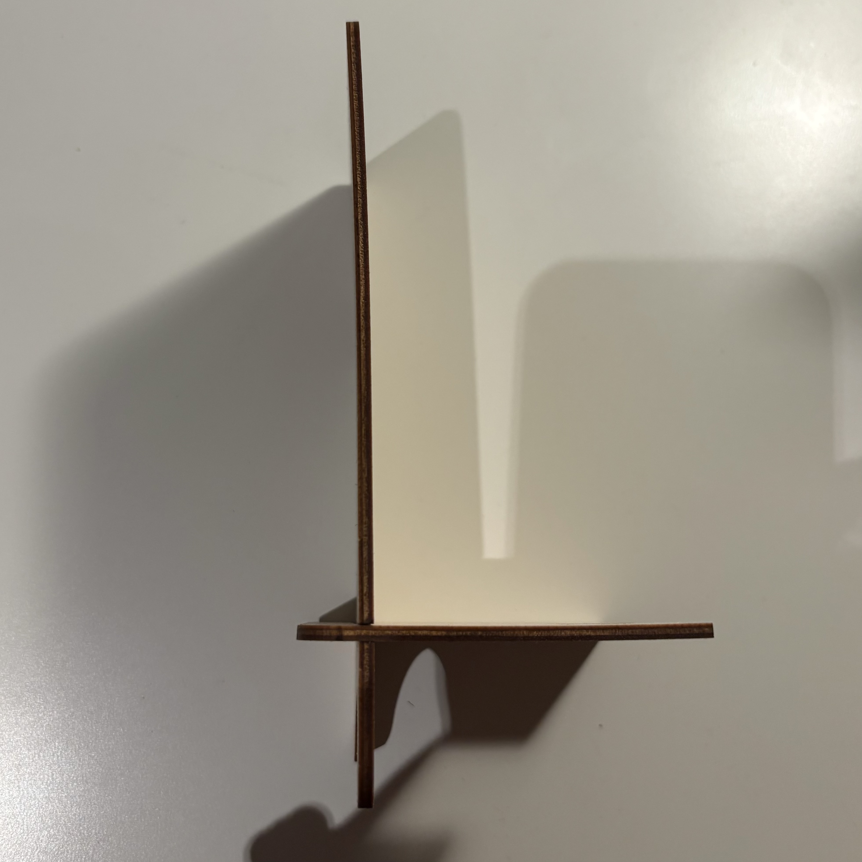 The edge of the cut board became dark, showing how the laser burned the wood and how strong the energy was 