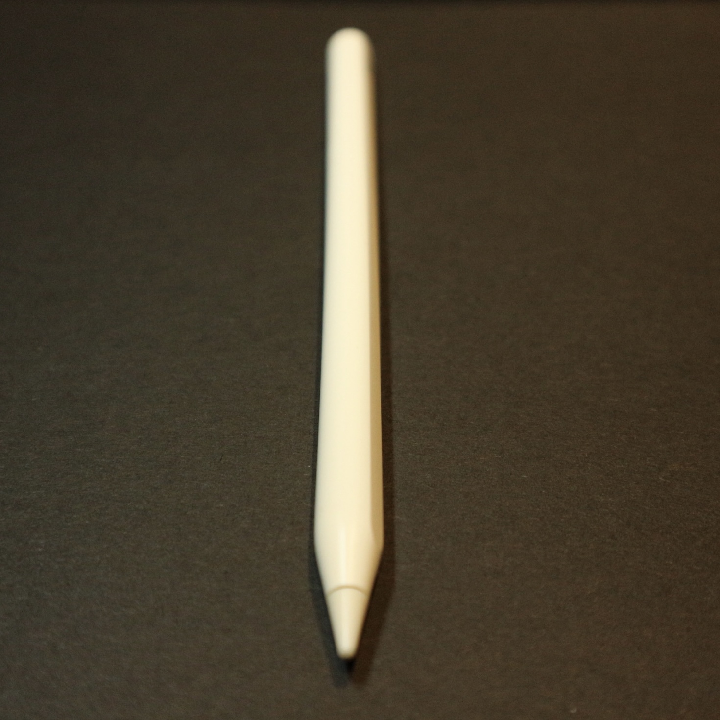 a white apple pencil poiting at the camera
