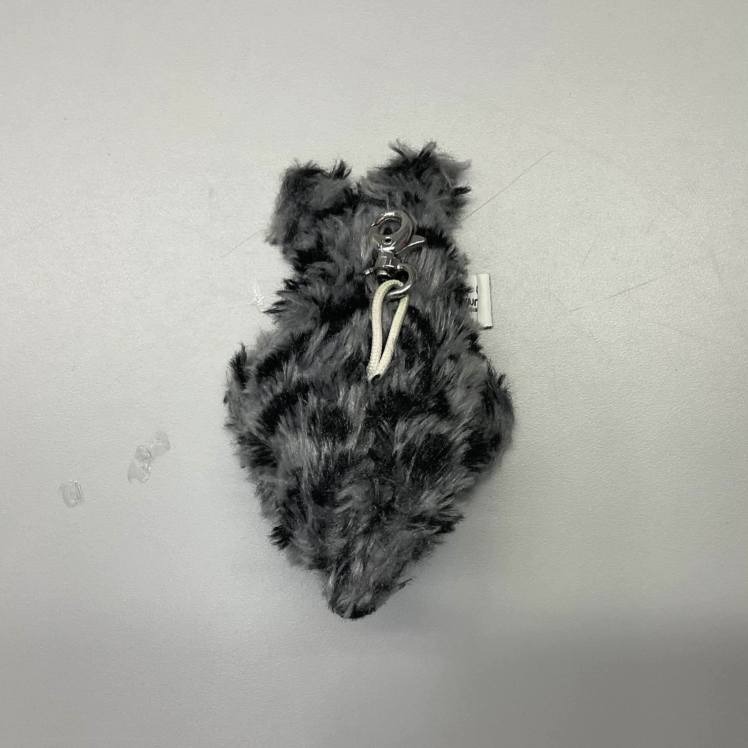 backdown view of a grey seaotter plush doll