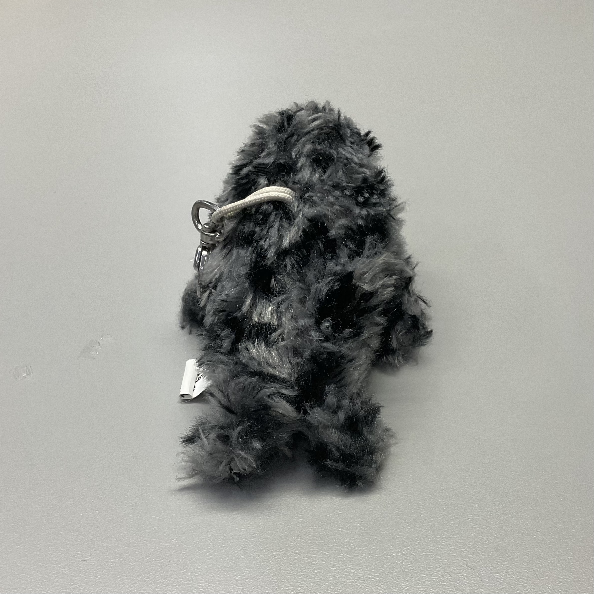 backup view of a grey seaotter plush doll