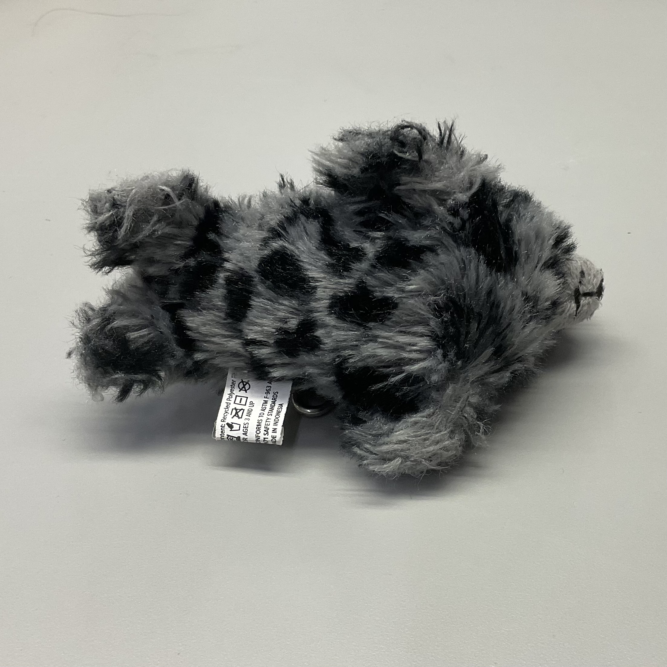 bottom view of a grey seaotter plush doll